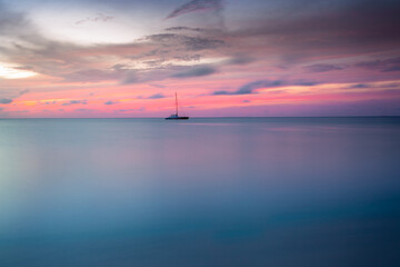 Aruba idyllic caribbean beach with boats at sunset, Dutch Antilles Sea