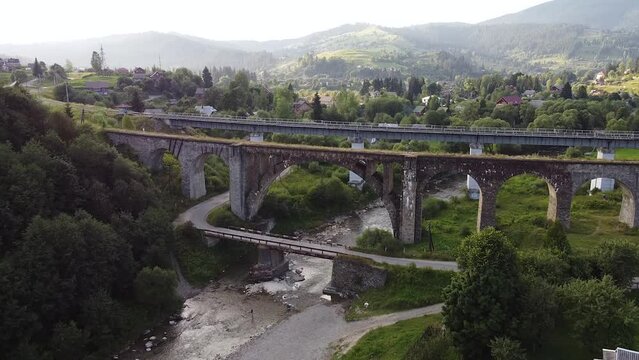 viaduct over the river in the mountains shot by drone. Bridge in mountains 