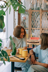 mother and daughter spend time together in a cafe