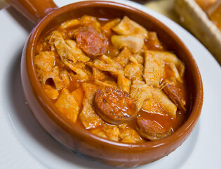 Dish of Spanish cuisine - stew with beef tripe and blood sausage chorizo
