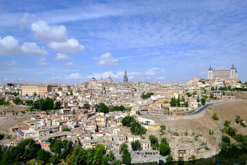 Fototapeta na wymiar View of Toledo, Spain. It is a World Heritage Site by UNESCO. Famous landmarks such as the Primatial Cathedral of Saint Mary of Toledo, Alcázar of Toledo, and the Tagus River are seen.
