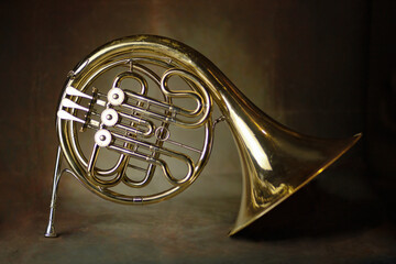 french horn an ancient musical metal instrument popular in classical brass music an instrument...