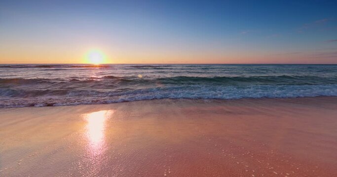 Ocean beach sunrise. Ocean waves washing sea sand 4k slow motion video
