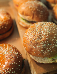 Beautifully decorated catering banquet table on event with different food snacks and appetizers setting with bagel and sandwiches, triange, baguette club submarine sandwich, on a wooden plate