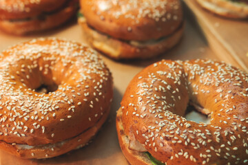 Beautifully decorated catering banquet table on event with different food snacks and appetizers setting with bagel and sandwiches, triange, baguette club submarine sandwich, on a wooden plate
