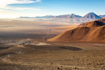 Fototapeta na wymiar Atacama desert, snowcapped volcanoes and arid landscape in Northern Chile