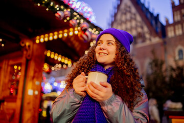 Young girl with drink on Christmas market in Wroclaw, Poland