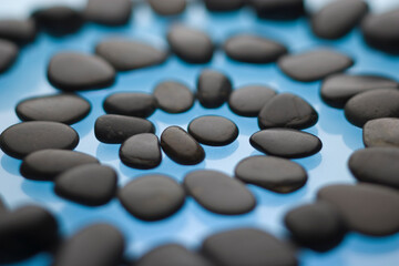 A spiral pathway of stones on a blue background.