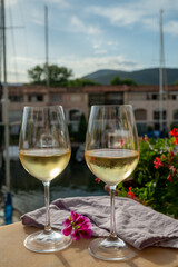 Drinking of cold white wine  with view on yacht harbour of Port Grimaud, summer vacation on French Riviera, France