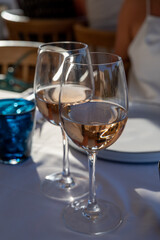 Dinner at sunset in French restaurant with cold dry rose wine in Port Grimaud, summer vacation on French Riviera, France