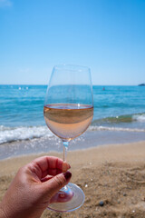 Cold rose wine from Provence served outdoor on white sandy beach Plage de Pampelonne near Saint-Tropez, France