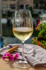 Drinking of cold white wine  with view on yacht harbour of Port Grimaud, summer vacation on French Riviera, France