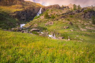 Ethereal waterfall and alpine meadows at springtime, Gran Paradiso Alps, Italy