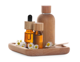 Bottles of chamomile essential oil and flowers on white background