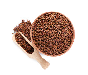 Wooden bowl and scoop with buckwheat tea granules on white background