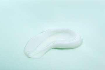 Sample of body cream on color background