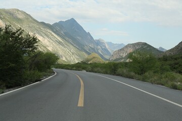 Naklejka premium Beautiful view of empty asphalt highway near mountains outdoors. Road trip