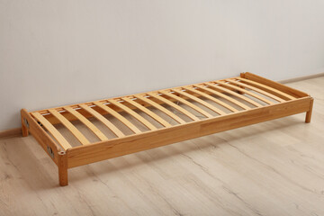 Wooden bed frame on floor in room