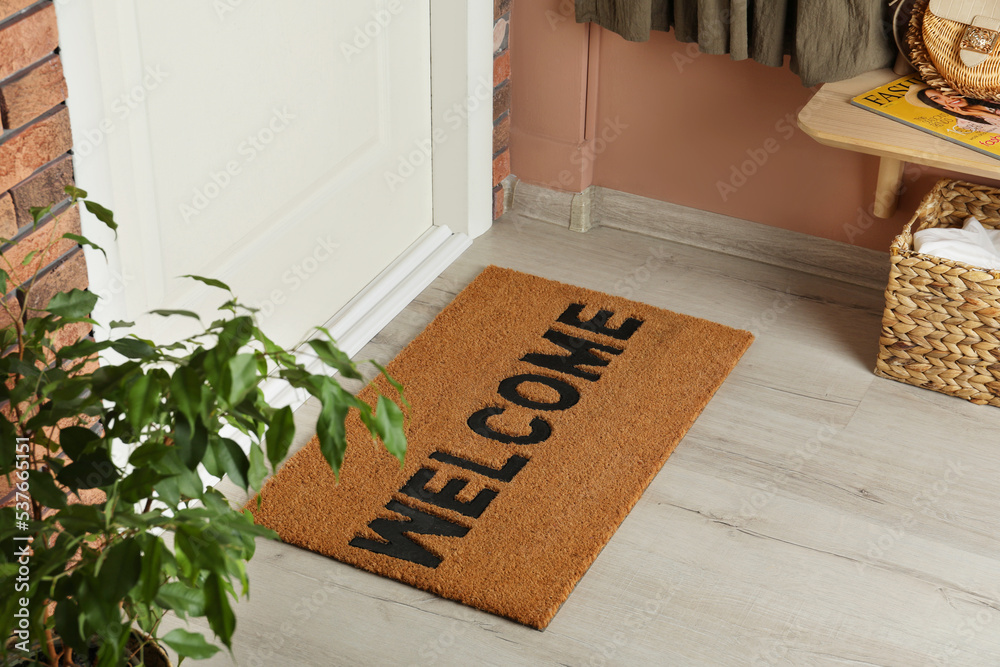 Poster Door mat with word Welcome on wooden floor in hall