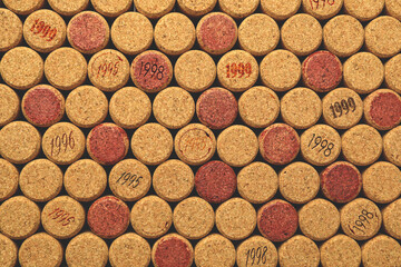 Many wine corks with different dates as background, top view