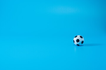 Fototapeta na wymiar Plastic Toy Football Isolated On Blue Background