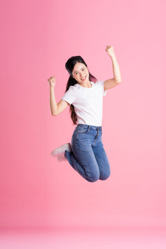 Full Body Image Of Asian Girl Posing On Pink Background