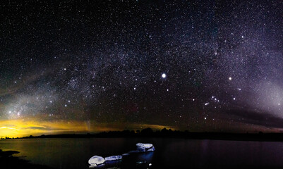 panoramic of nightscape in a lake, and moonshines in one side, dark side of milky way in gamboas...
