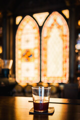 Glass of alcohol on a bar counter close-up view