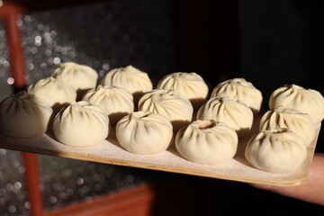 Fototapeta premium Traditional Buryad Cuisine Food with Chopped Meat and Dough. Preparing Making Dumplings Close-up 
