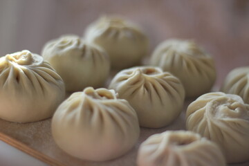 Traditional Buryad Cuisine Food with Chopped Meat and Dough. Preparing Making Dumplings Close-up	

