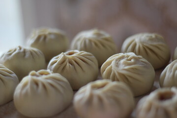 Traditional Buryad Cuisine Food with Chopped Meat and Dough. Preparing Making Dumplings Close-up	
