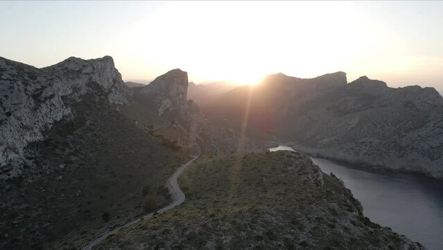 Beautiful sunset behind the mountains of Formentor Cape in the north of Mallorca aerial view