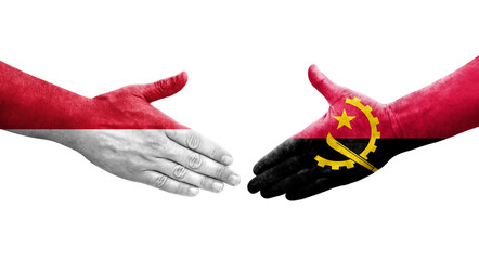 Handshake between Angola and Monaco flags painted on hands, isolated transparent image.