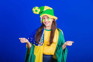 young girl, soccer fan from Brazil. dressed in hat and flag. calling with your hands.