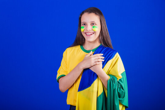 Young Girl, Soccer Fan From Brazil. Dressed In Flag, Singing National Anthem. Gratitude.