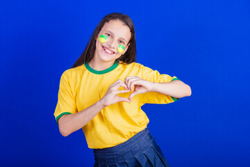 young girl, soccer fan from Brazil. heart sign love.