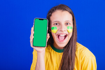 young girl, soccer fan from Brazil. holding cellphone, screen for advertisement, promotion....