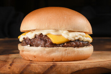 tasty hamburger sandwich with tomato onion salad and bread isolated on black background