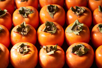 row of Ripe persimmon fruit background.Close up of fresh kaki