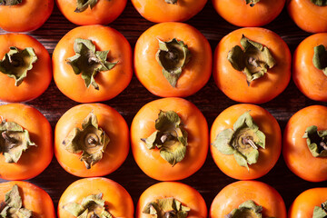 row of Ripe persimmon fruit background.Close up of fresh kaki