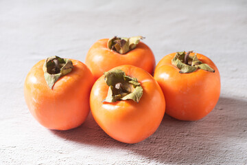 Ripe persimmon or kaki fruit on table.