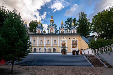 Fototapeta na wymiar View of the Assumption Cathedral in the Holy Dormition Pskov-Pechersk Monastery on a sunny summer day, Pechory, Pskov region, Russia
