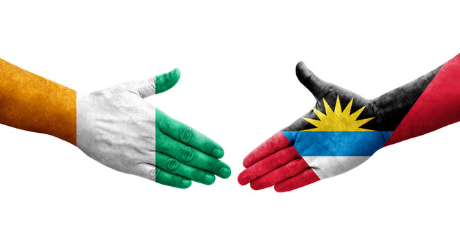 Handshake between Antigua and Barbuda and Ivory Coast flags painted on hands, isolated transparent image.