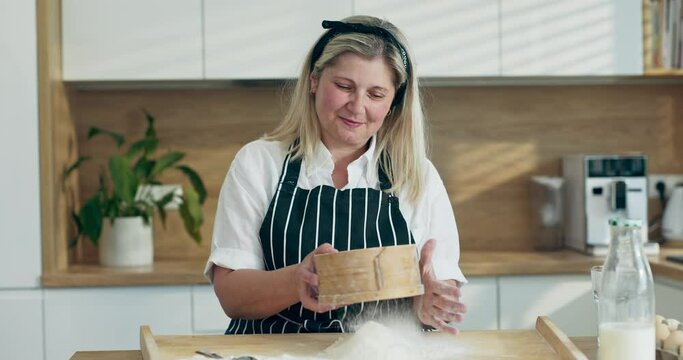 Woman sifting flour through sieve on wooden surface using kitchen tools spoon preparing baking cooking homemade pizza pasta making surprise for family dinner.