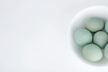 duck egg is in a white bowl on white background