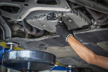 Car automatic transmission fluid change service in garage service shop.