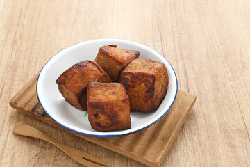 Tahu Bacem, traditional food from Central Java, Indonesia, cooked with spices, palm sugar and coconut water. Boil, then fry briefly.
