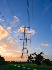 High voltage pole on silhouette sunset background