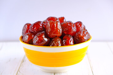 Chinese jujube red preserved in syrup. in the yellow bowl
