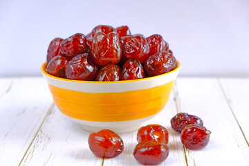 Chinese jujube red preserved in syrup. in the yellow bowl

